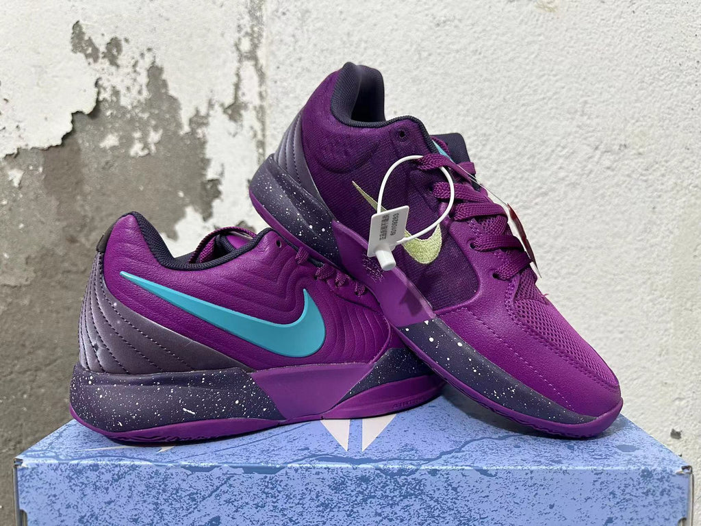 Pair of purple Nike basketball shoes with turquoise and pale green Swoosh accents