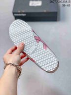 Close view of the sneaker outsole showing a repeating textured traction pattern and Onitsuka Tiger branding.