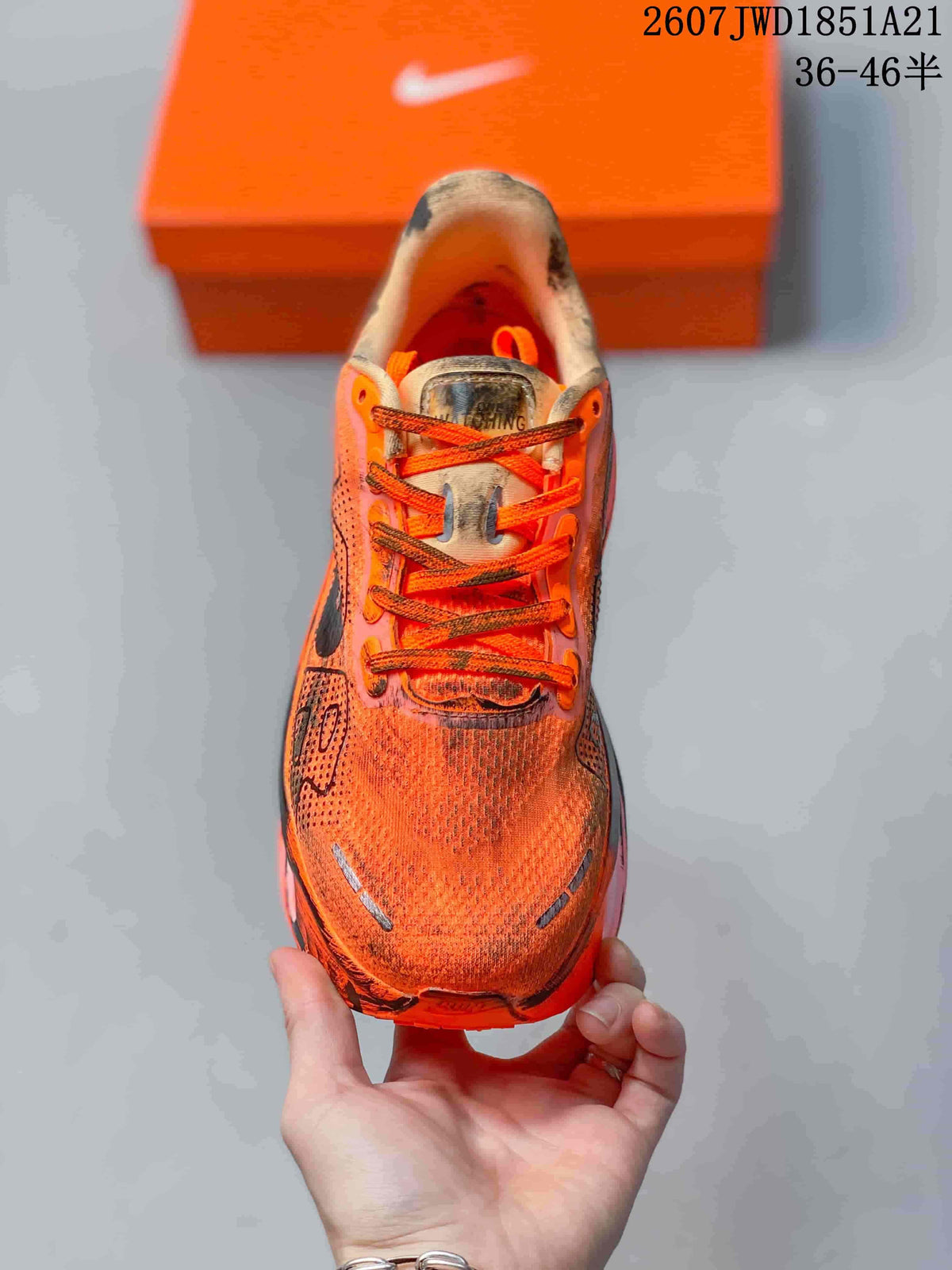 Top view showing the orange laces, tongue and textured orange toe box.