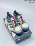 Pair of adidas Terrex hiking shoes in beige, green, burgundy and navy displayed on a Terrex shoebox.