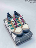 Pair of adidas Terrex hiking shoes in beige, green, burgundy and navy displayed on a Terrex shoebox.