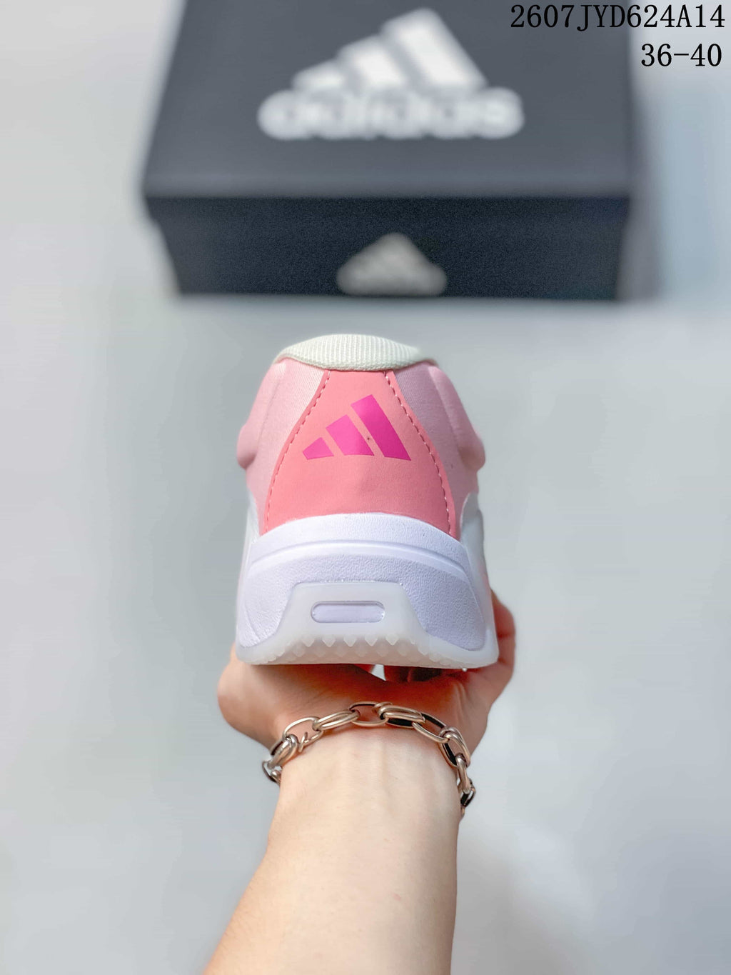 Rear view showing the pink heel panel, adidas logo and white midsole.