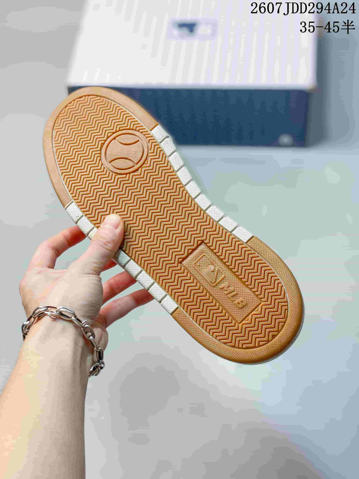 Close view of the gum-colored outsole with a repeating zigzag tread pattern and central embossed branding.