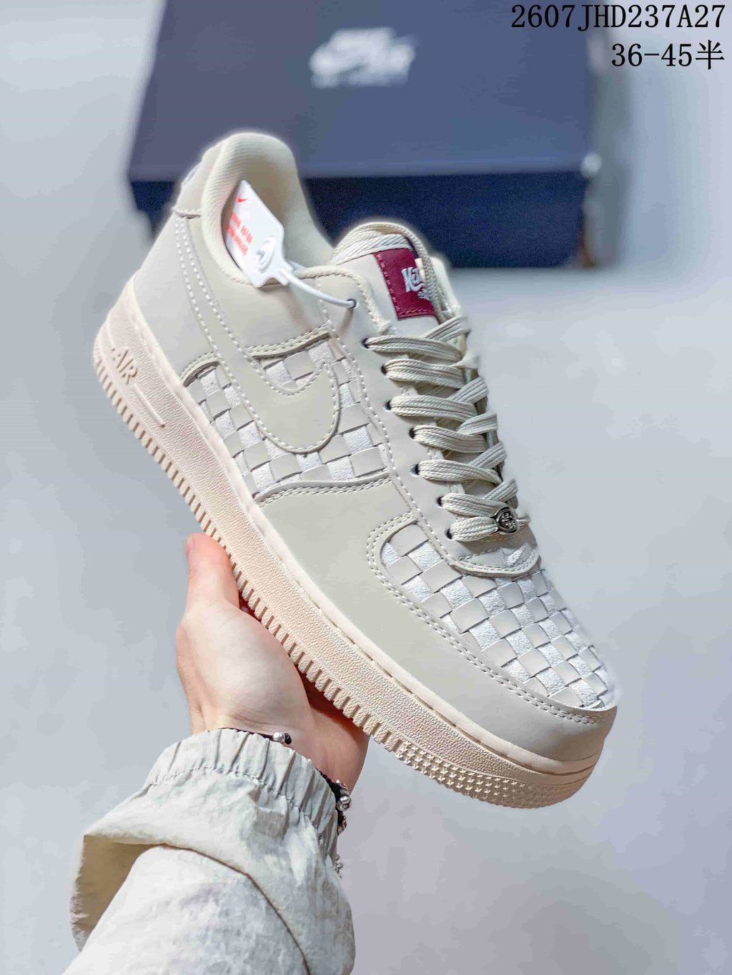Angled side view showing the woven toe and side panels, tonal swoosh, laces, and textured sole.