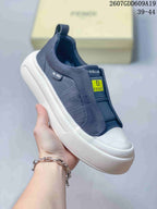 Side view of a navy Fendi slip-on sneaker showing the elasticated upper, heel pull tab, side detail, and white textured sole; image text lists sizes 39–44.