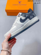 Side view of the low-top sneaker with dark patterned panels and white upper