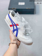 White low-top sneaker with blue and red side stripes and translucent ribbon laces.