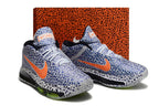 Pair of patterned blue and white Nike GT Hustle 3 shoes in front of a matching patterned box.