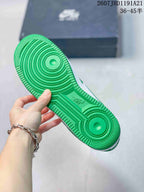 Close-up of the green rubber outsole showing circular traction zones and molded tread details.