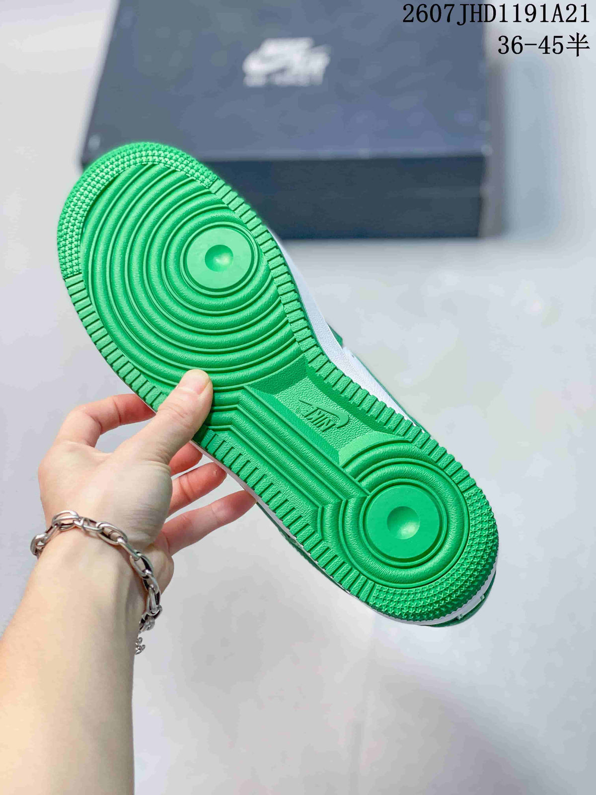 Close-up of the green rubber outsole showing circular traction zones and molded tread details.
