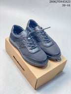 Pair of dark navy ECCO lace-up sneakers shown on a shoebox