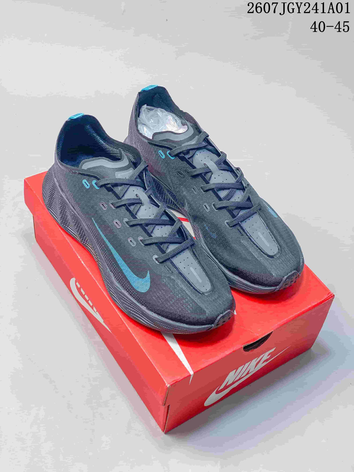 Pair of charcoal gray Nike AVA X low-top shoes with blue accents on a red shoe box