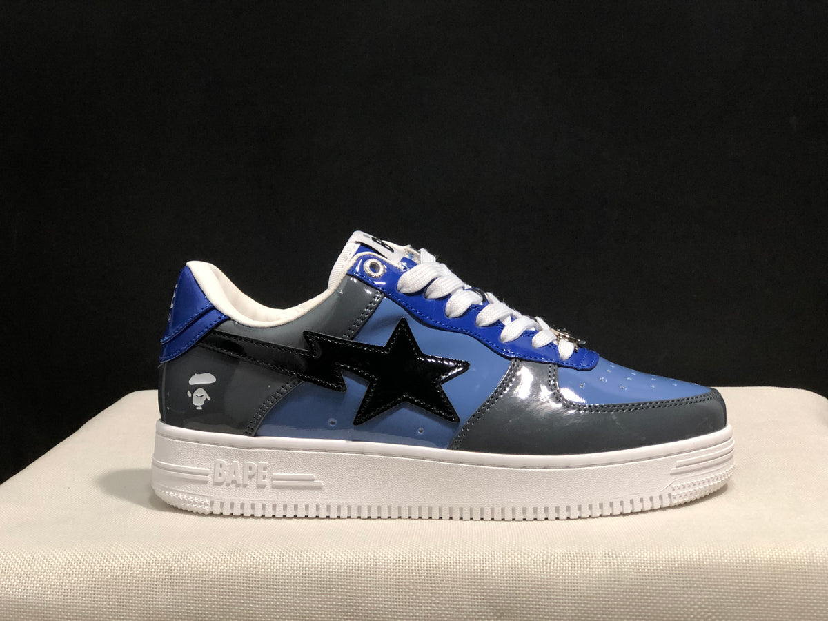 Close side profile showing the glossy blue and gray upper, black star detail, and white Bape-branded sole.