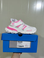 White and pink low-top sneaker displayed on a blue shoe box; the box label shows Track Forum Low Top, White/Pink, and size C 37.