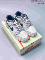Pair of white and navy low-top sneakers displayed on a Nike shoe box, with style code 2607ND1601A11 and size range 36–45.5 visible above.