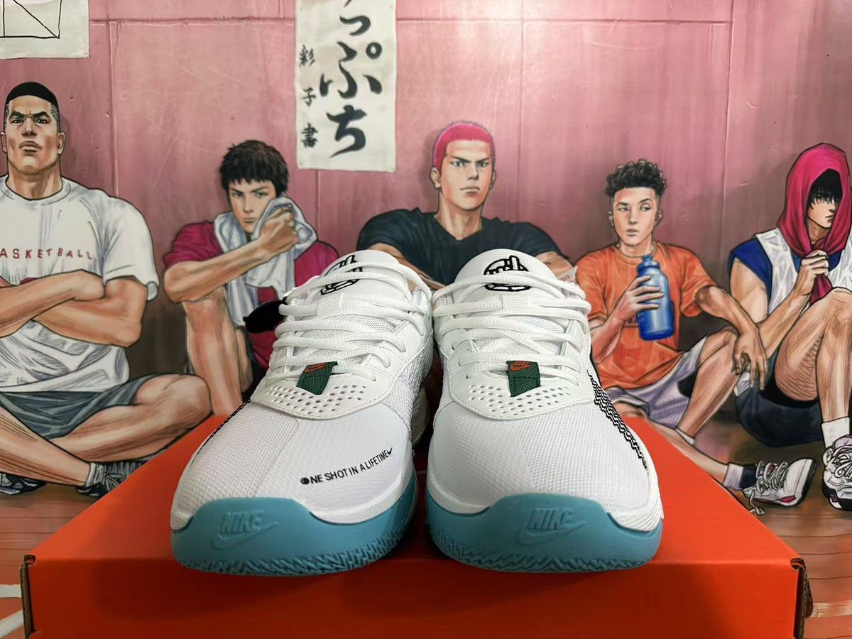 Front view of white Nike basketball sneakers with white laces, perforated toe panels, blue-green toe outsoles, and small dark branding details.