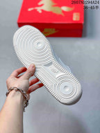 Underside view of the white sneaker showing the circular traction pattern and textured rubber outsole.