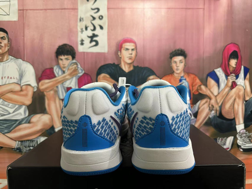 Rear view of white and blue Nike basketball shoes showing patterned heel panels and blue heel accents.
