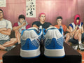 Rear view of white and blue Nike basketball shoes showing patterned heel panels and blue heel accents.