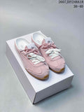 Pink alo Sunset mule sneakers with white and pink laces displayed on a white shoebox.