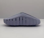 Lateral view of the purple slide showing vertical side vents and the raised outsole profile.