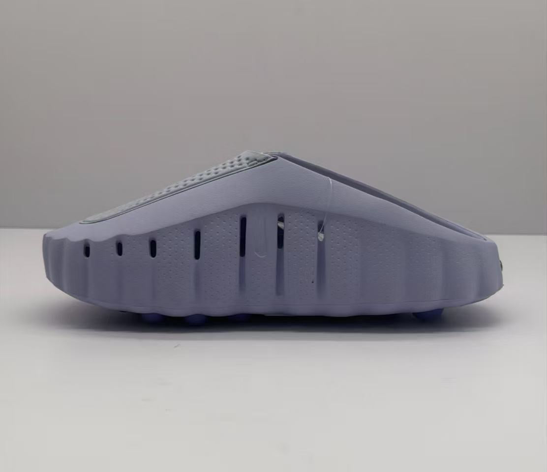 Lateral view of the purple slide showing vertical side vents and the raised outsole profile.