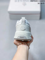 Rear view of the white sneaker showing the Moncler heel emblem, pull tab and Vibram branding on the sole.