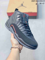 Angled side view of the dark high-top sneaker showing the padded collar, lace system, red side accent, and textured outsole.