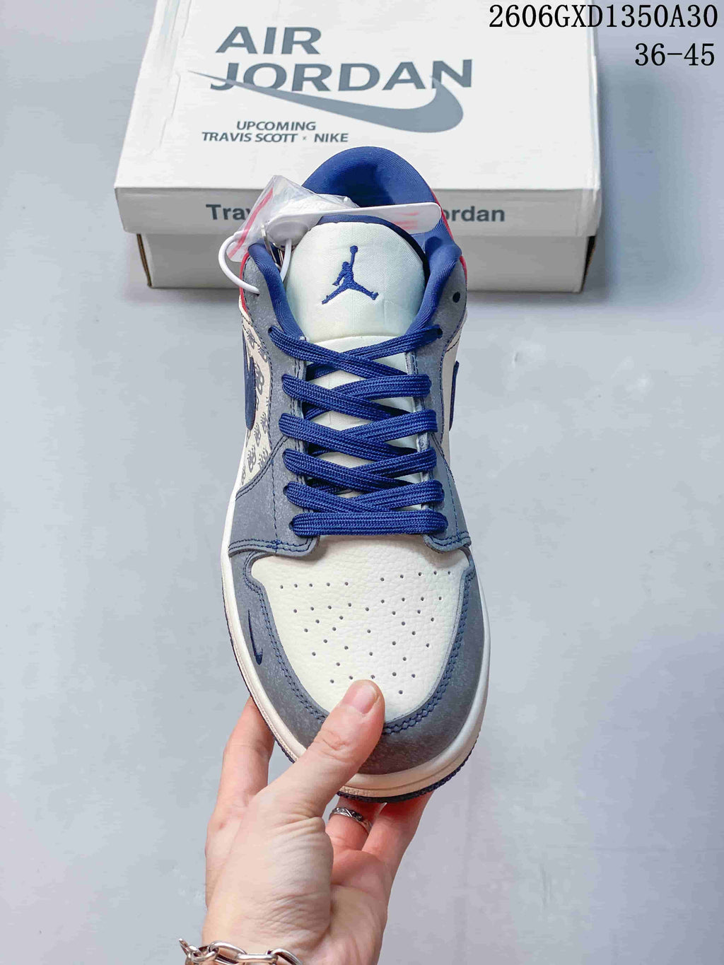 Front view showing perforated off-white toe, grey overlays, and blue laces