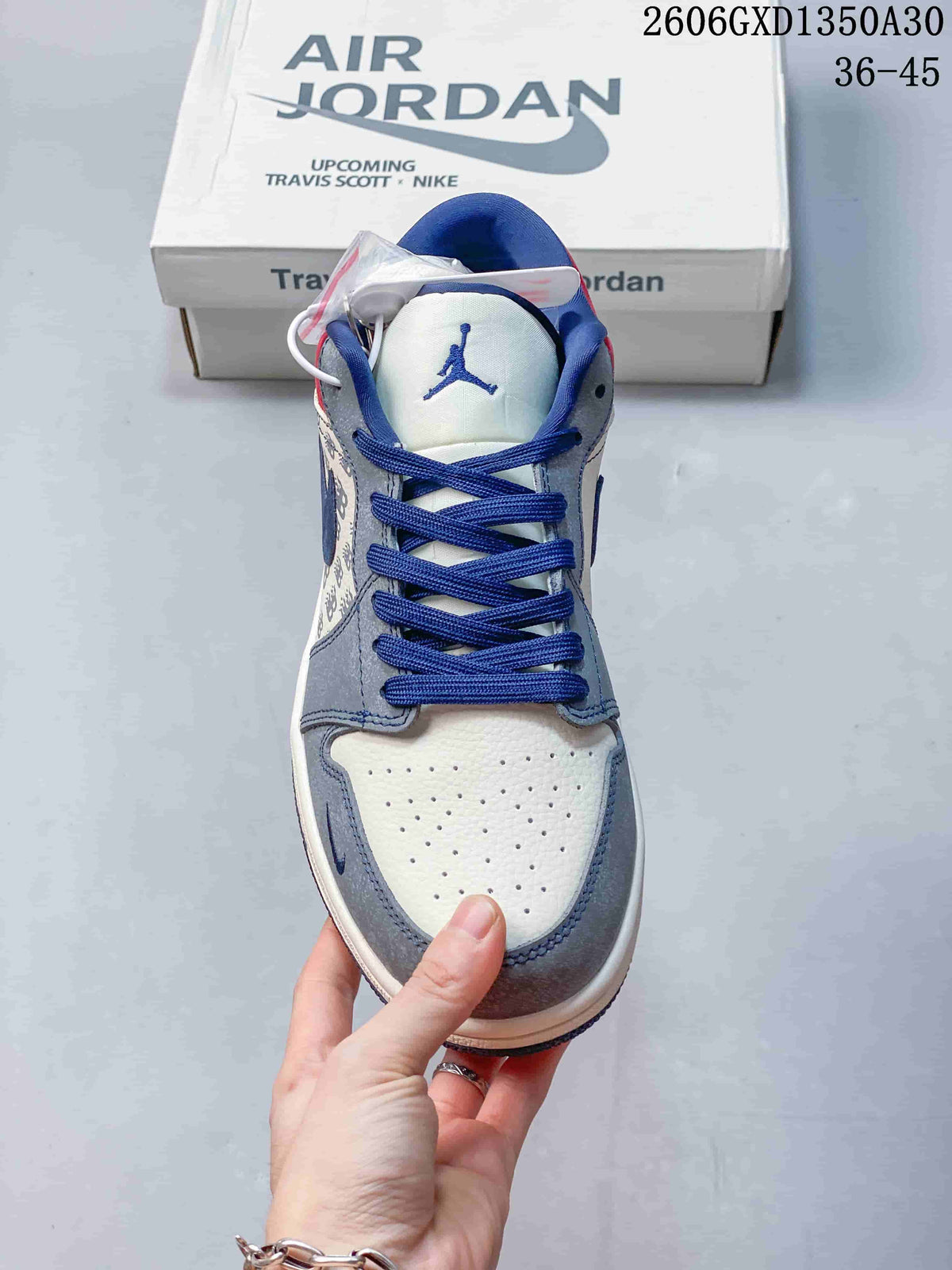Front view showing perforated off-white toe, grey overlays, and blue laces