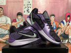 Pair of black and purple Nike Sabrina basketball shoes shown from the side.