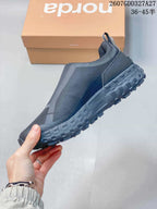 Side profile of the dark charcoal slip-on sneaker showing tonal panels, elasticated upper construction, pull tab, and rugged outsole; overlay text shows style code 2607GDD327A27 and sizes 36–45.