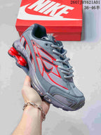 Angled side view of the grey and red Nike Shox Ride 2 sneaker