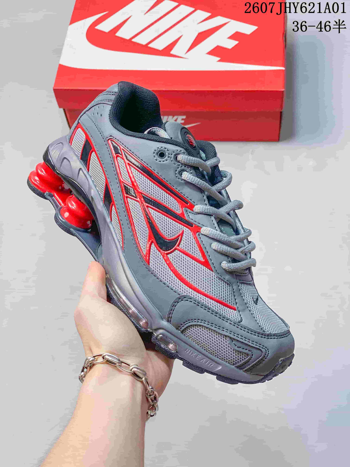 Angled side view of the grey and red Nike Shox Ride 2 sneaker