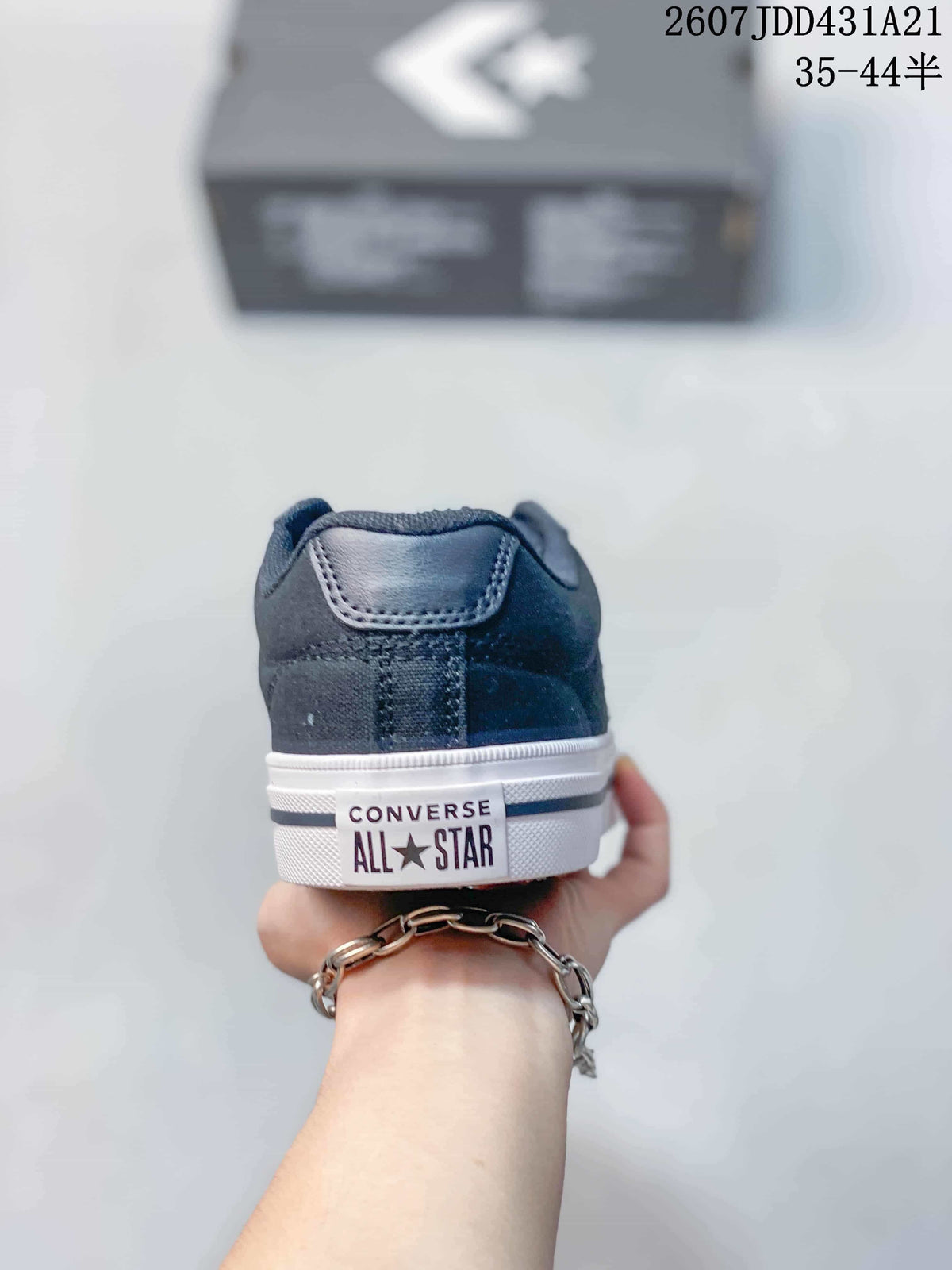 Rear view of the navy sneaker showing the heel panel, white midsole, and Converse All Star branding.