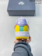 Rear view of the multicolor sneaker showing the lavender heel tab, yellow and turquoise heel panels, white midsole and yellow outsole.