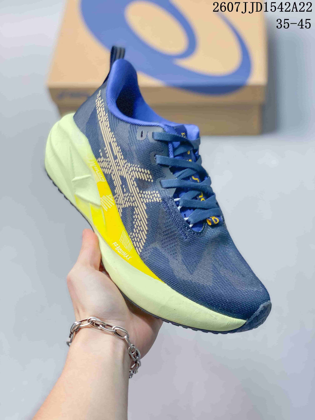 Angled side view showing the navy upper, patterned side panels, yellow accent and lime midsole.