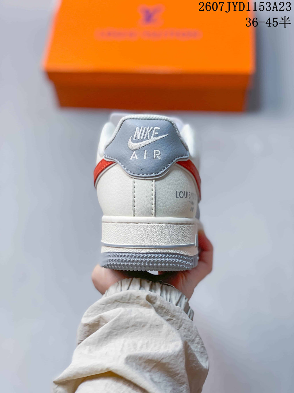 Rear view showing the padded heel, Nike Air branding, white midsole, and grey outsole.