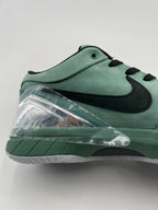 Close-up of the green side panel, black Swoosh and clear heel piece