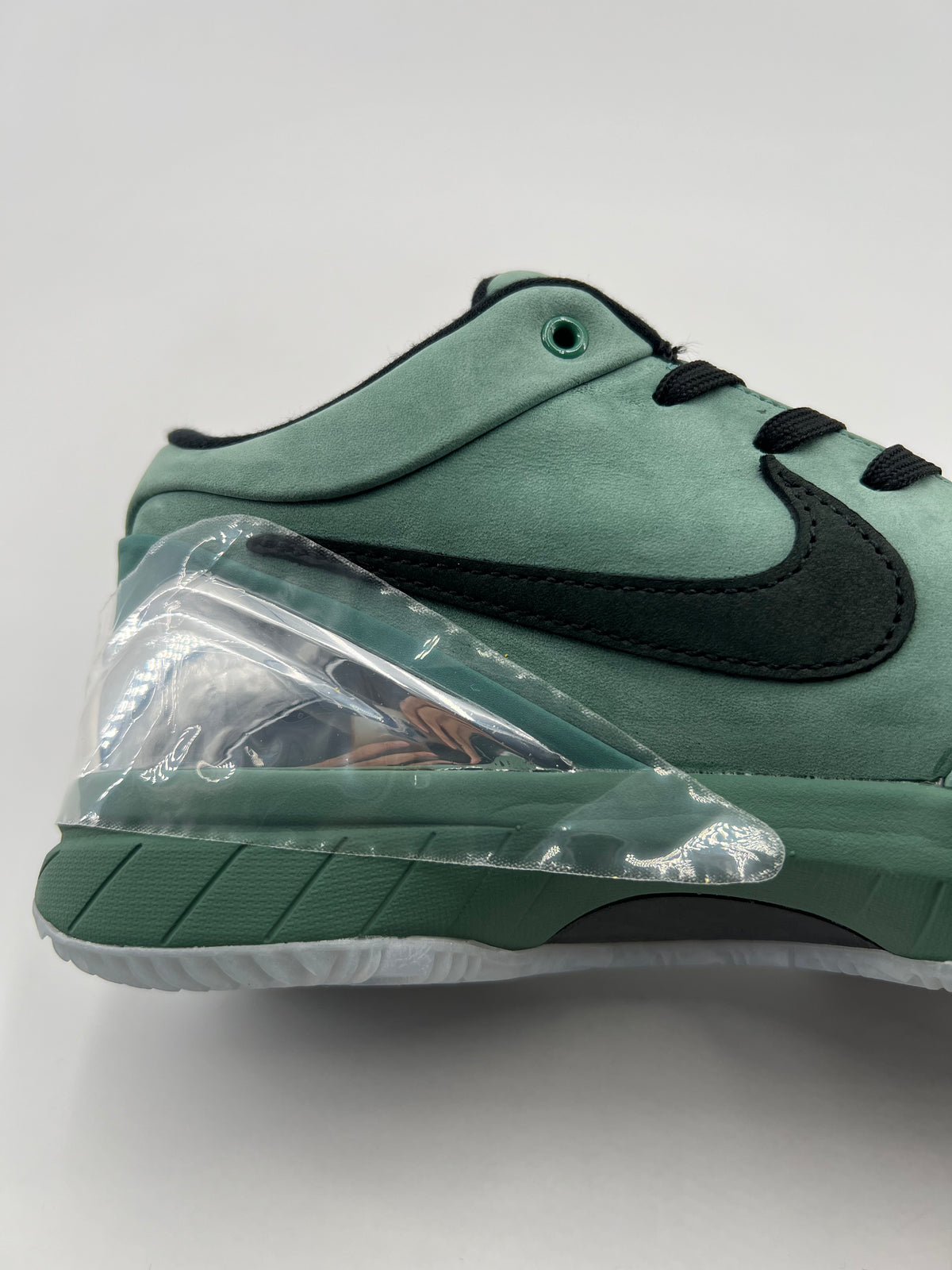 Close-up of the green side panel, black Swoosh and clear heel piece