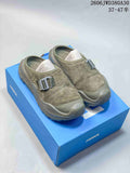 Pair of olive-toned HOKA ONE ONE Ora Primo EXT mule sneakers on a blue shoe box
