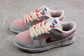 Pair of pink, white, and gray low-top sneakers with brown Swooshes, cream laces, and cherry heel details.