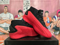 Pair of black and red Adidas high-top basketball shoes shown from the side.