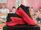 Pair of black and red Adidas high-top basketball shoes shown from the side.