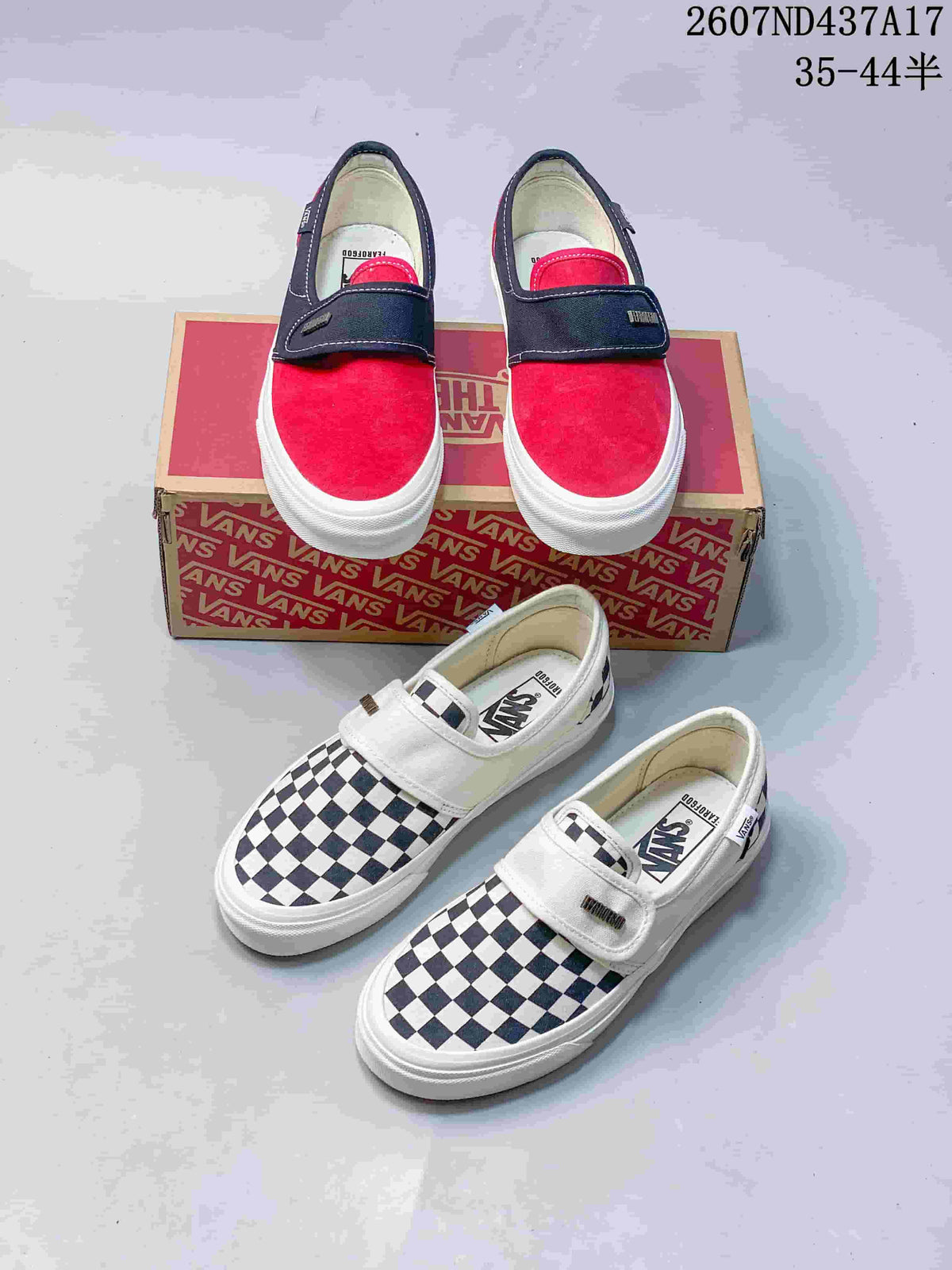 Both shown color options of the Vans slip-on sneakers: red and navy, plus black-and-white checkerboard; a Vans shoebox is visible behind them.
