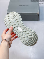Close-up of the sneaker’s pale sage-colored lugged outsole and tread.