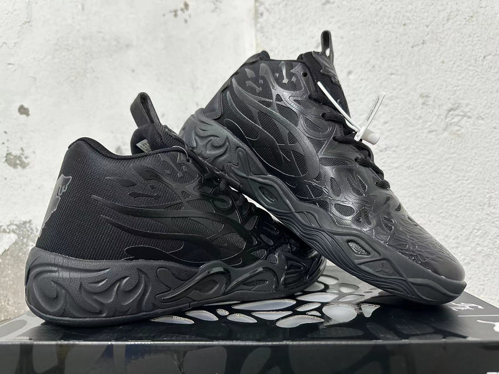 Pair of black high-top basketball shoes shown at an angle, highlighting the tonal design and sculpted outsole.
