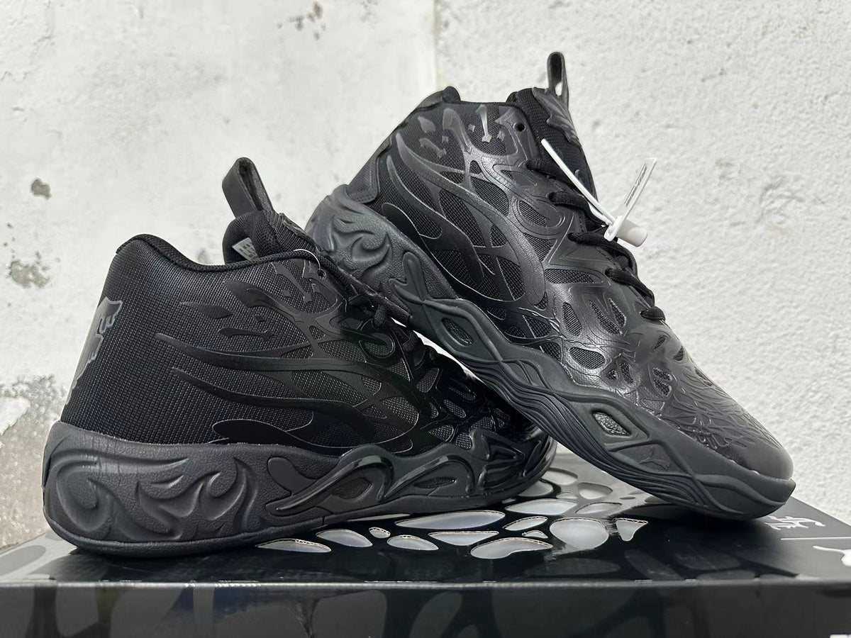 Pair of black high-top basketball shoes shown at an angle, highlighting the tonal design and sculpted outsole.