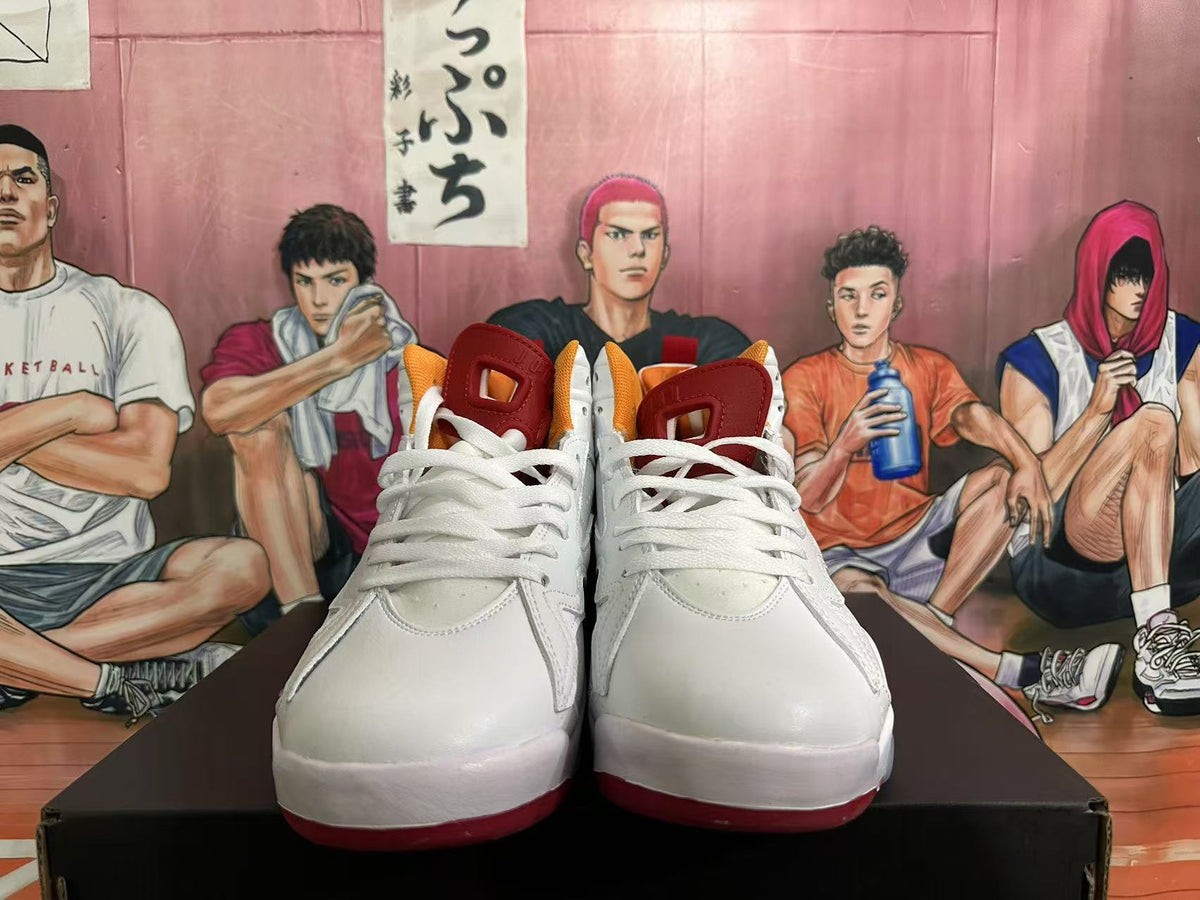 Front view of white high-top sneakers with white laces and red tongues.