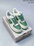 White and green Nike Air Force 1 '07 low sneakers with green laces and floral side detailing, displayed on a patterned shoebox.